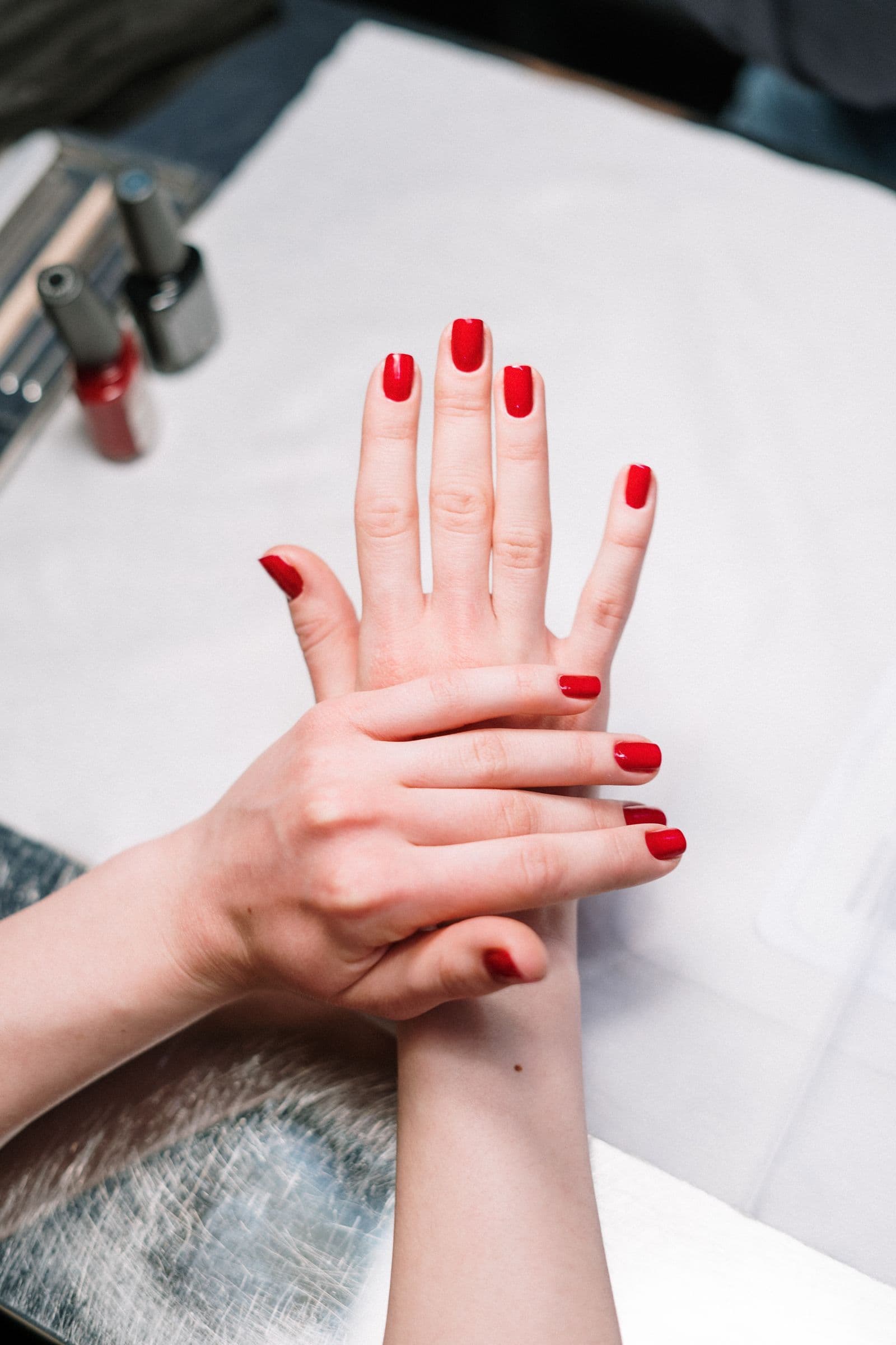 Close-up of a glossy red shellac manicure